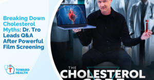 Promotional banner for Dr. Tro's cholesterol myths Q&A after a film screening, with a presenter holding a laptop showing a heart image beside the blue event text.