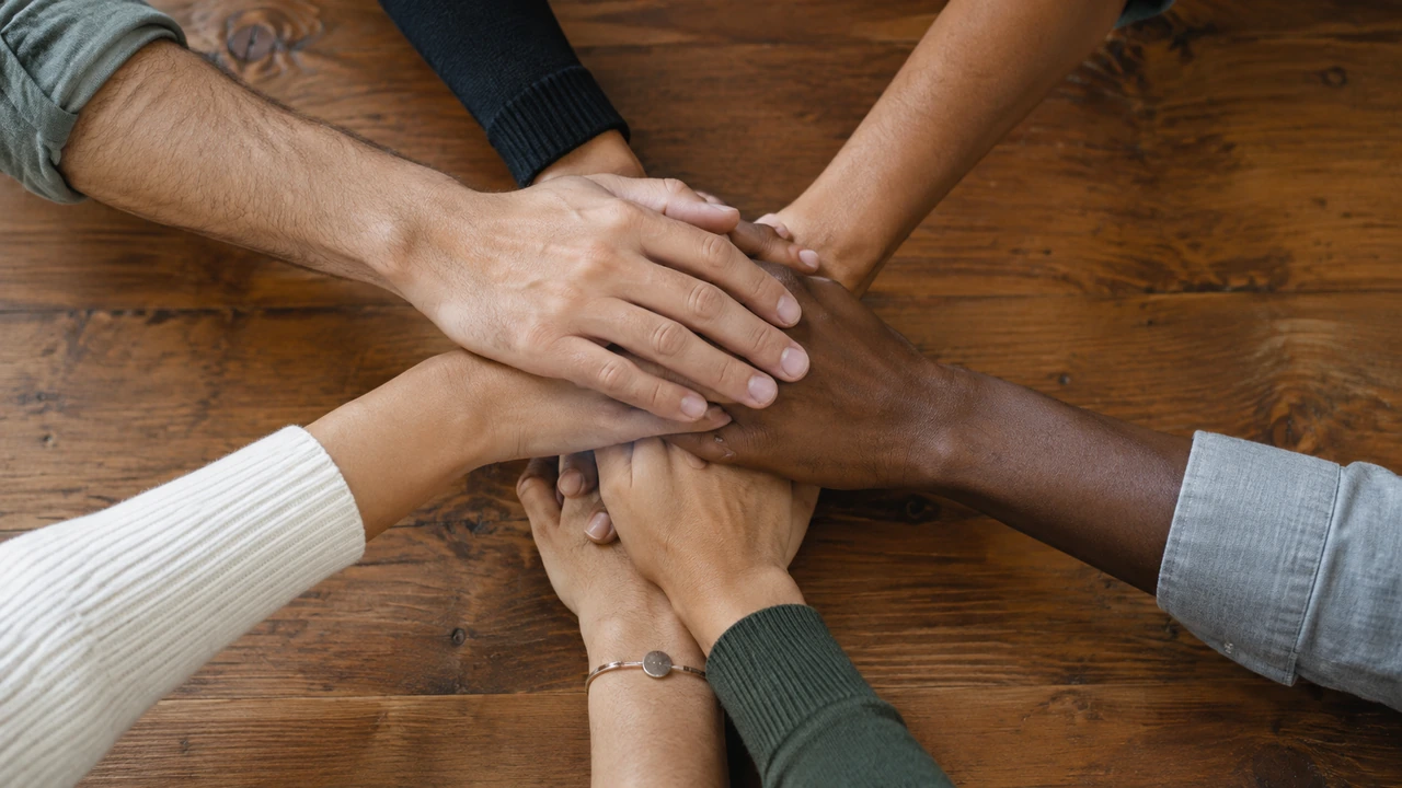 Health Isnt a Willpower Problem Its a People Problem editorial image - Toward Health Several hands stacked together on a wooden table.