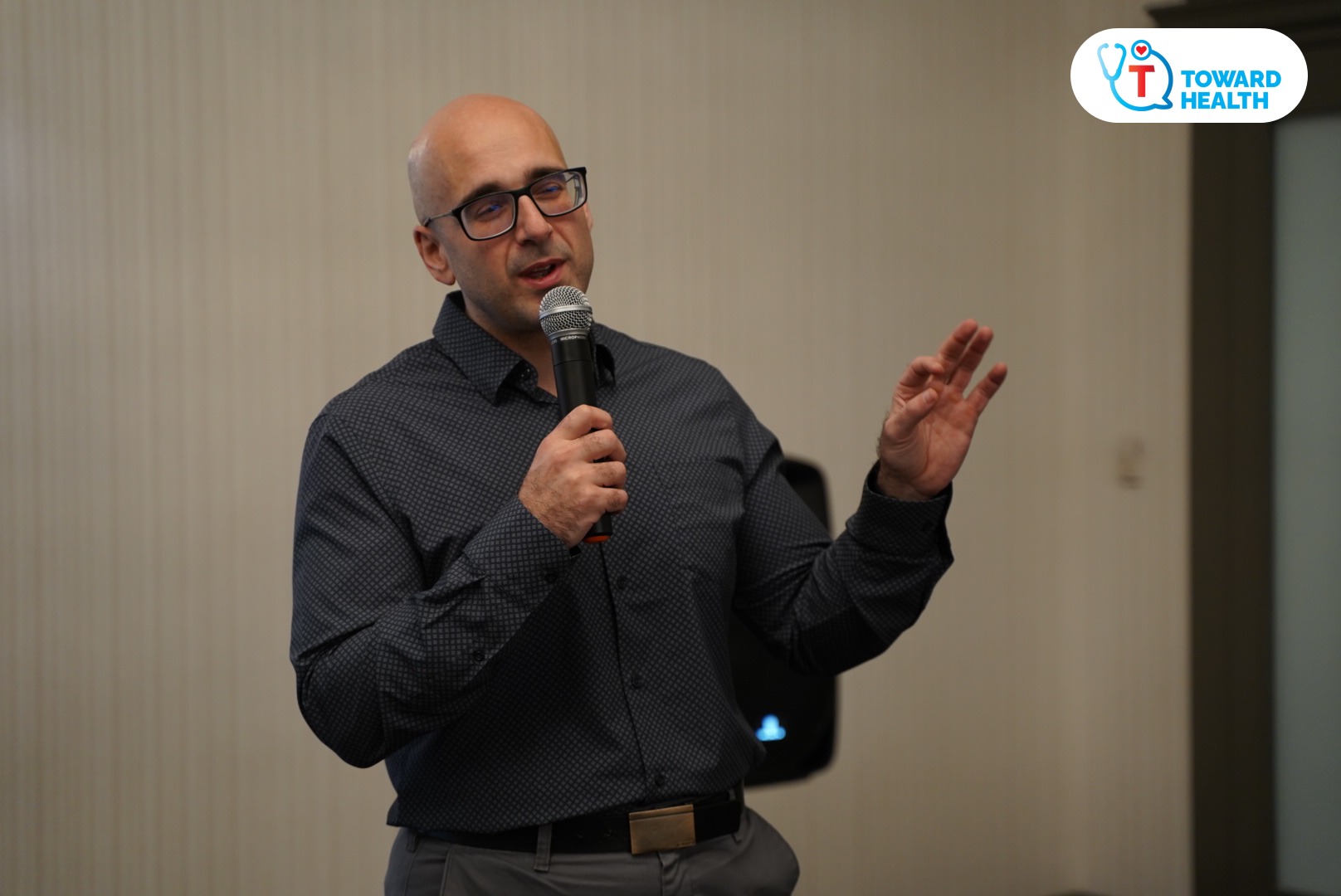 Dr. Tro Kalayjian speaking into a microphone